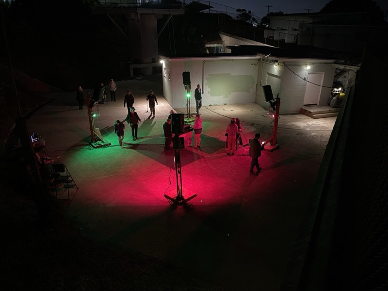 QUADRA/FRONTERA installation - Night scene with red and green lighting creating sonic spaces